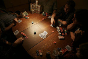 People playing 3 card poker at a table